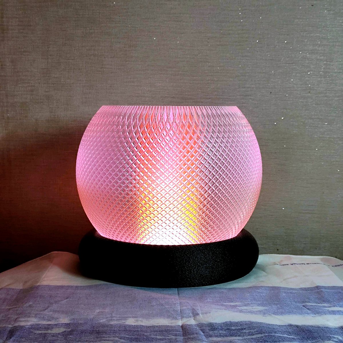 Hero shot of modern intricate 3D printed Diwali lamps casting kaleidoscopic geometric light patterns on dark textured surface. Glowing warmly from inside with golden amber light, framed by neon cyan teal and purple ambient rim lighting. Dark studio photography, high precision 3D printing layers visible, festive modern aesthetic.
