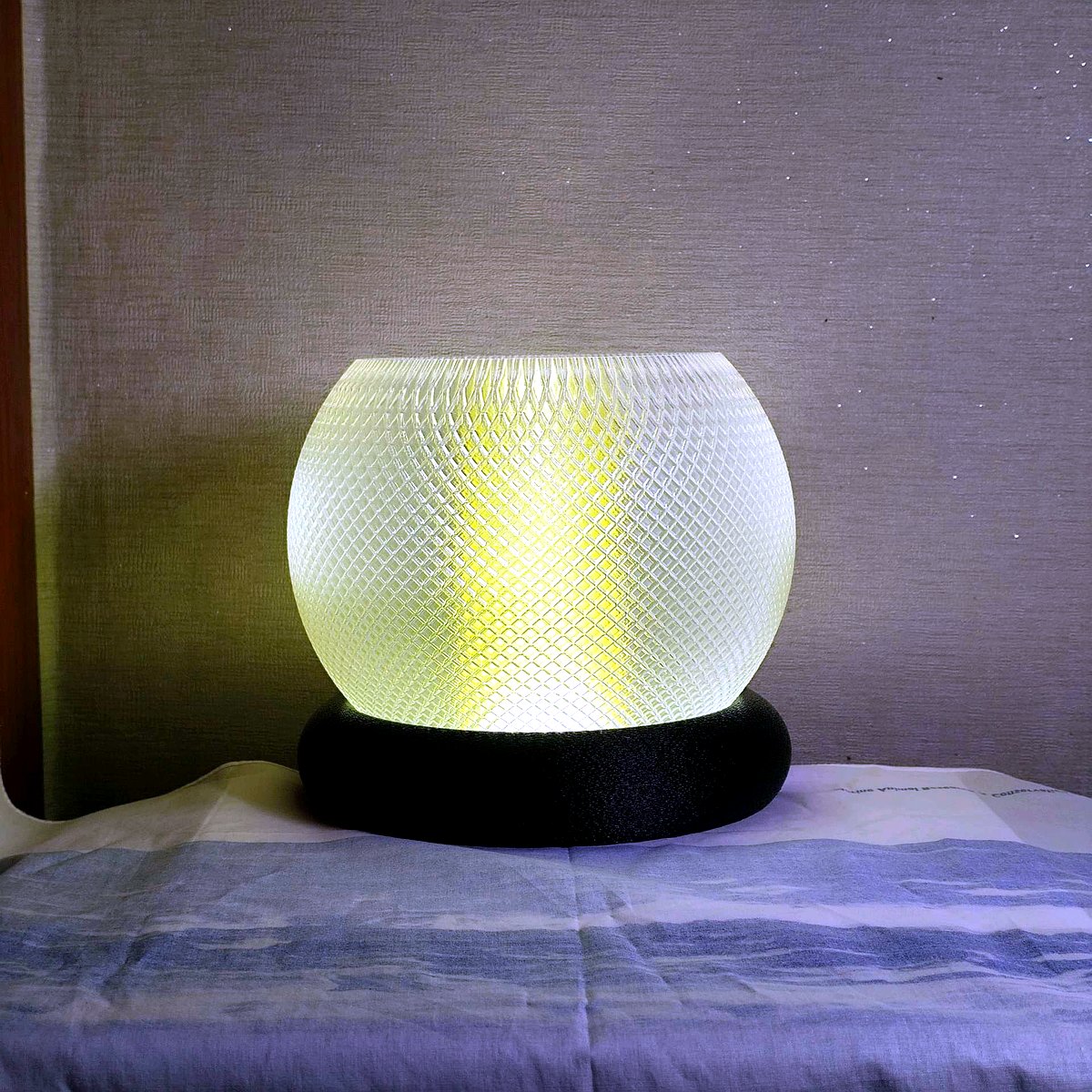 Large 3D printed floor and tabletop statement lantern lamp with intricate geometric mandala cutouts, glowing amber and warm golden light through layered PLA 3D printed shell, subtle purple rim glow, dark luxury product photo.